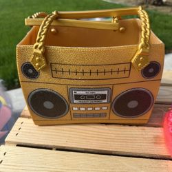 This is a L.O.L. Surprise! Ooh La La Baby Surprise Lil D.J. boombox purse case. 