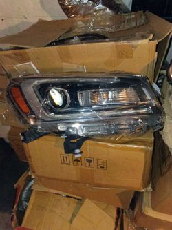 driver-side headlight assembly for a 2013-2016 GMC Acadia.