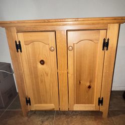 Solid pine free standing cabinet with shelf.