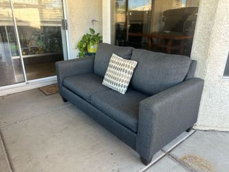 Grey couch with bed