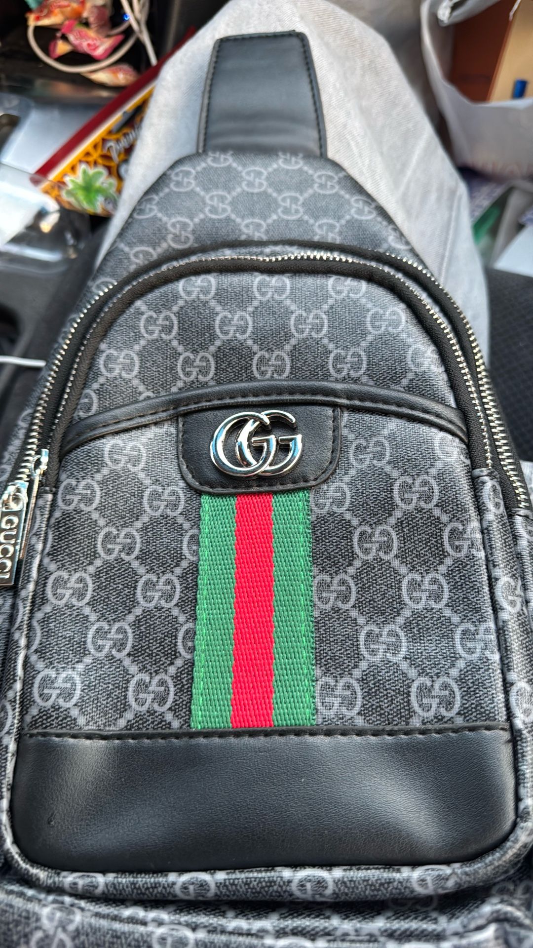 Gucci,goes over chest dark gray and size is adjustable