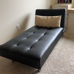 Black faux leather lounge chair and sleeper 