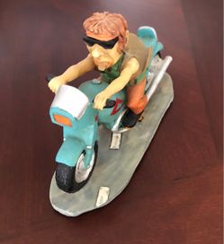 Vintage  comical resin figurine featuring a stylized biker riding a teal motorcycle,  Size 8 inches x 5-1/2 inches $15
