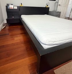 Queen bed with attached nightstand