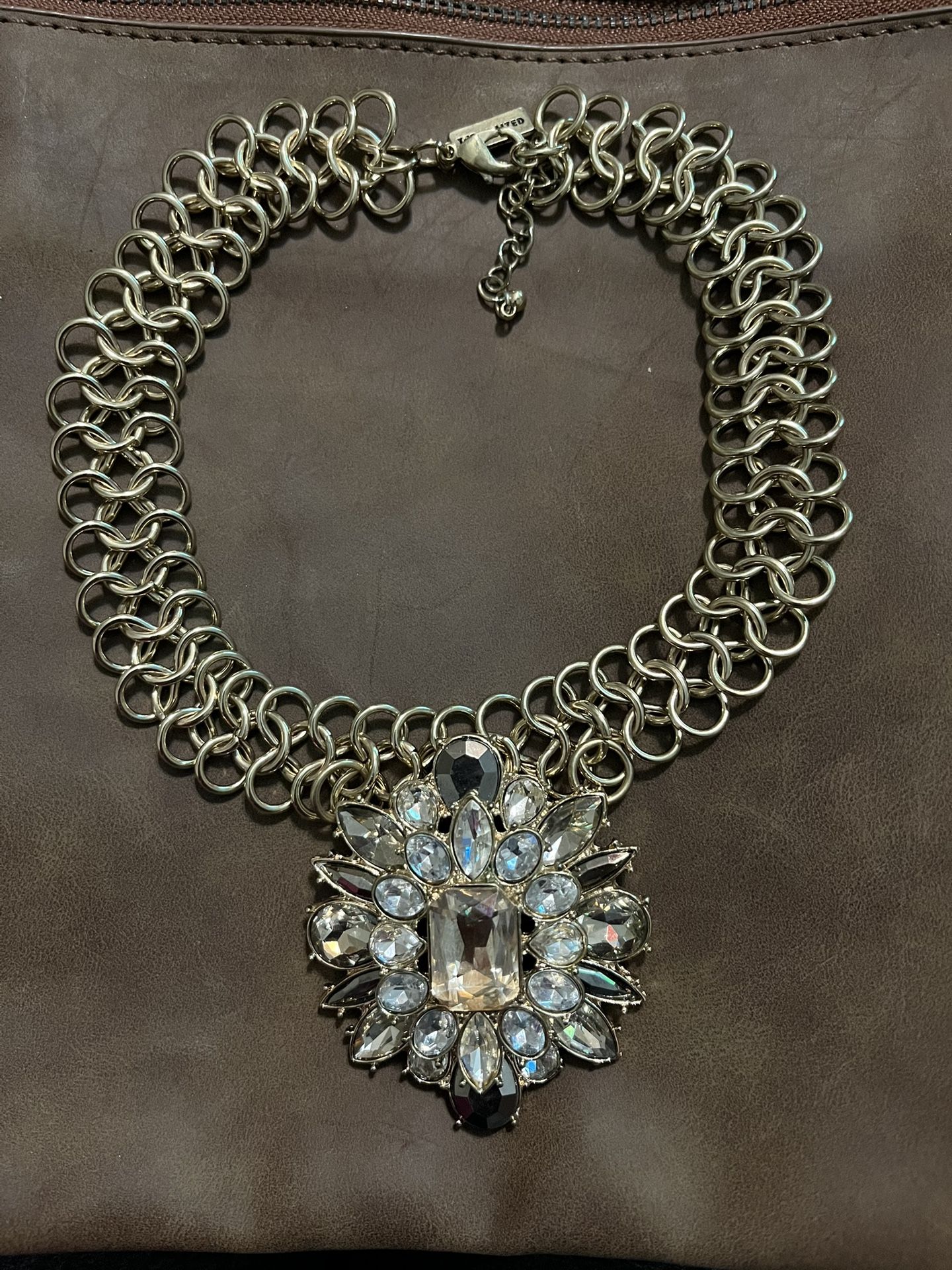 This is a choker-type necklace with a floral statement pendant adorned with rhinestones, from The Limited$35