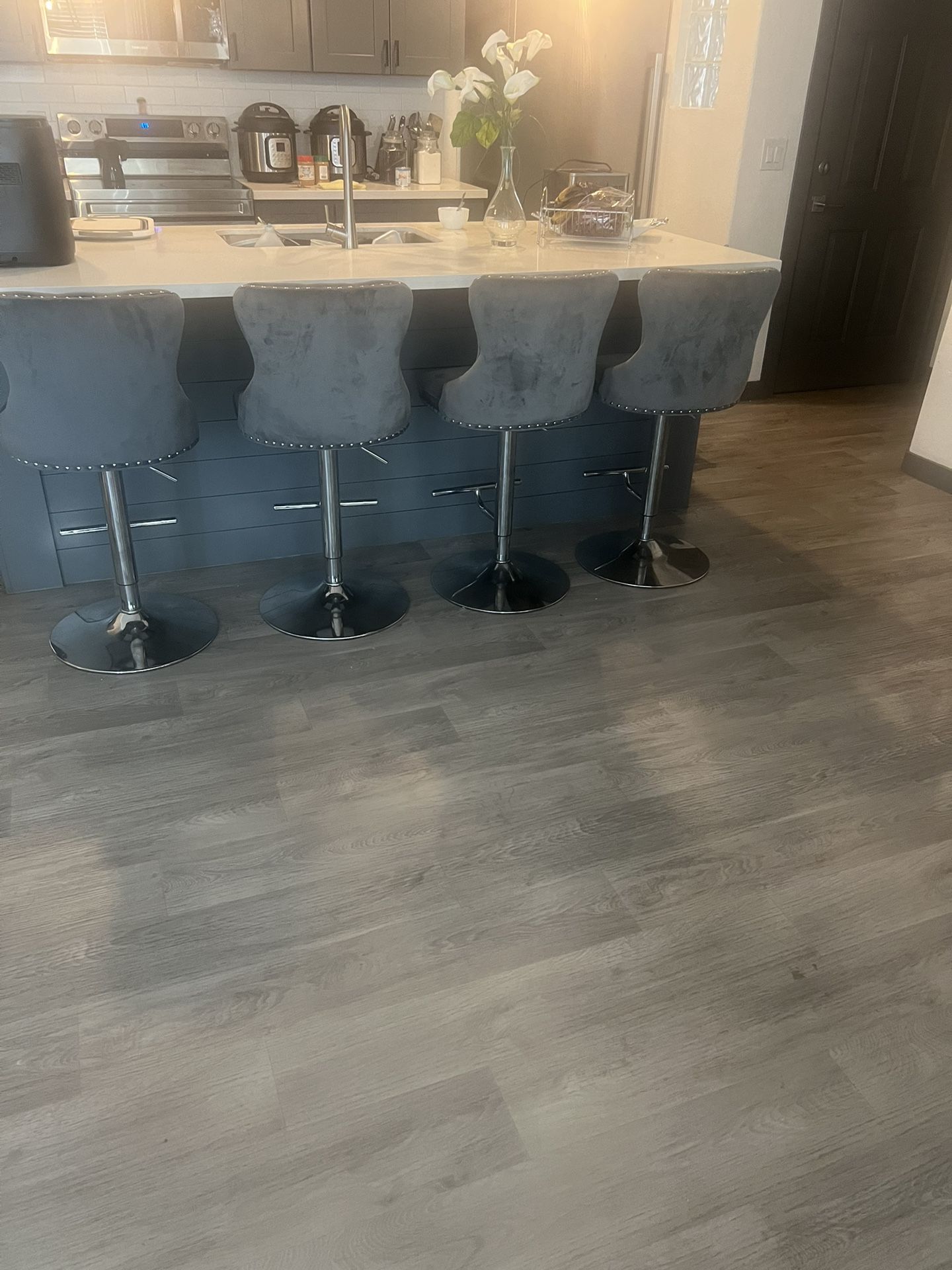 The Sectional And Bar Stools Are Grey