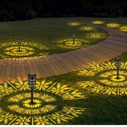 BRAND NEW IN BOX Solar Outdoor Lights Garden, 8 Packs Dynamic Pattern Solar Lights,2 Changeable Patterns Pathway Lights,Waterproof Solar Powered Lands