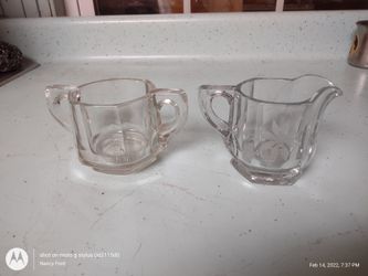 glass creamer and a glass sugar bowl

