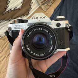 Canon AE-1 Program 35mm Film Camera with regular and zoom lens.