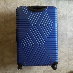 Blue hard shell suitcase with wheels and pull out handle