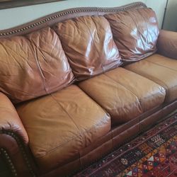 Brown leather studded sofa