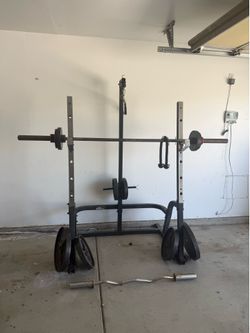 Squat rack with weights and bars. 45’s - 5’s