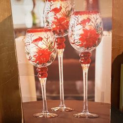 Set of 3 hand-painted Christmas glasses with a cardinal and poinsettia design. Candle holder with stand