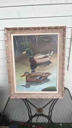 a framed painting of mallard ducks on a pond