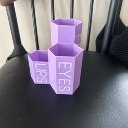 A set of three connected, hexagon-shaped containers