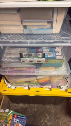 Box of school supplies books, stickers, firstaid, folders, clip board, crayon holders, workbook material 1st