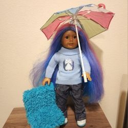 American Girl Doll With Chair and Umbrella. Has been played with Good Condition. It is possible that the hair is from a different doll. 