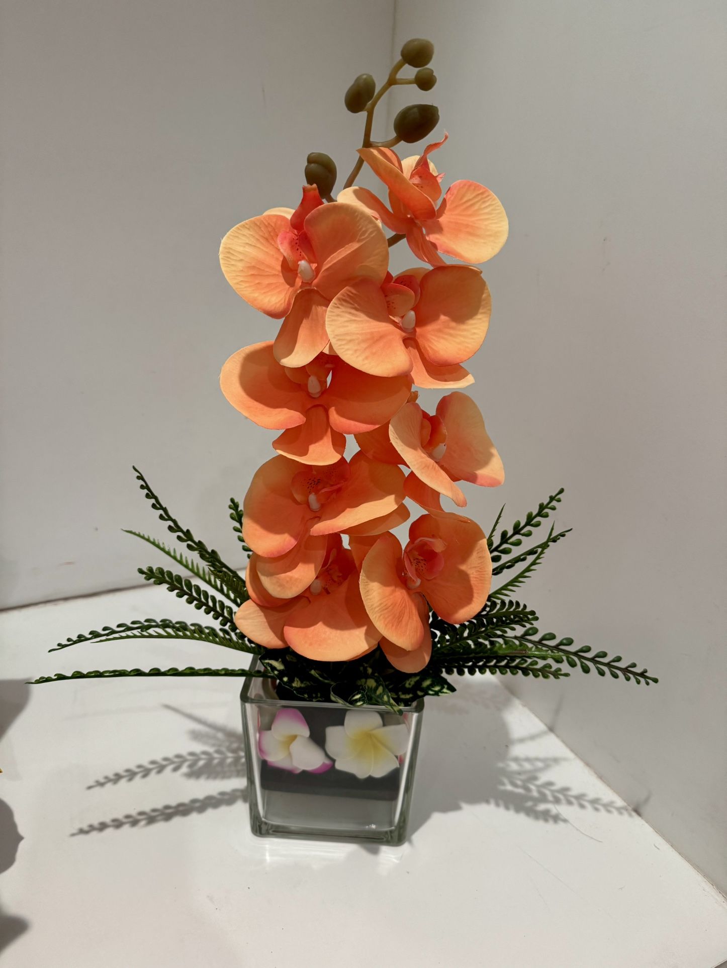 Orange Artificial Flowers In Glass Vase