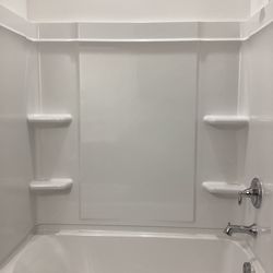 Bathtub with side panels and shower set
