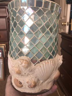 Mosaic light aqua candle holder with variety of seashells around the bottom 9”tall 5”diameter