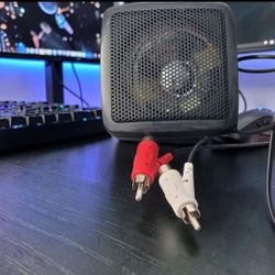 Wedge Style External CB Speaker Without Bracket 3.5mm Jack W/Audio Plug Adapter.  The product is a black wedge-style external CB speaker without a bra