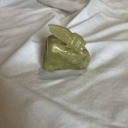 Carved cicada on rock