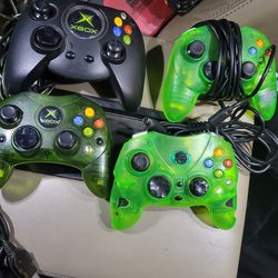 4 Xbox controllers, 1 OG  halo Green, 1 OG Duke, 2 aftermarket clear green