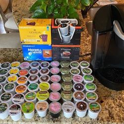 Keurig coffee maker machine and 118 Kcup pods + 1 water filter cartridge + 3 refillable pods. Just like new, only used a few times.
