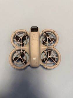 The image appears to show a DJI Neo palm-sized camera drone.Key DetailsType: Ultra-light mini droneWeight: About 135 gramsDesign: Built-in full propel