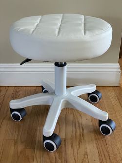 Small white rolling stool with cushioned seat