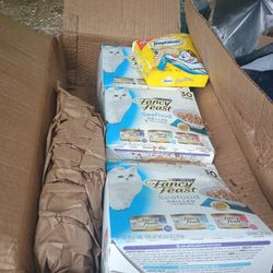 boxes of cat food and a box of purree