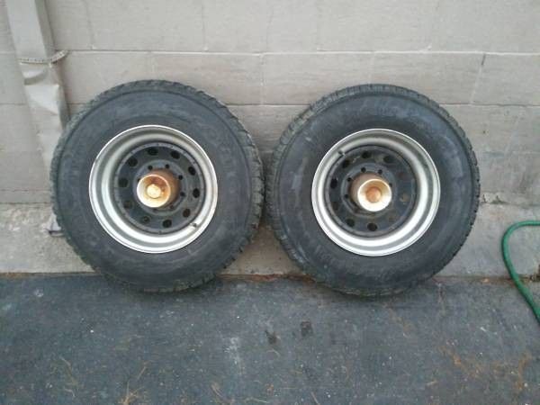two steel 8 lug 16.5 inch rims with 9.50-16.5 tires. Dodge Ford Chevy