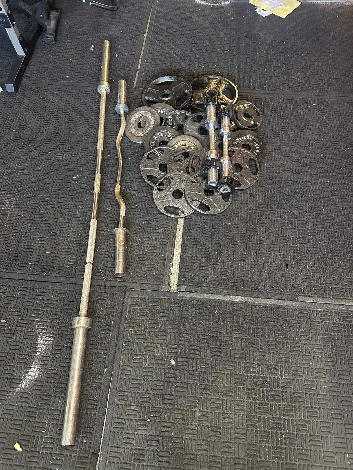 Olympic 7ft 45lbs bar plus 130lbs of Olympic weights and adjustable dumbbells plus cur bar