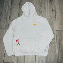 The Dandy Worldwide "Gift Giving" Oversized Lux Hoodie in Heather Grey is a stylish and cozy addition to any casual outfit. Made from a blend of polye