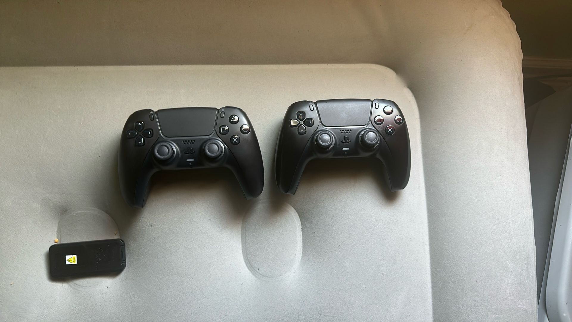 2 Black PS5 Controllers