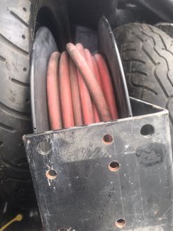 Compressor hose holder and reel mount system.