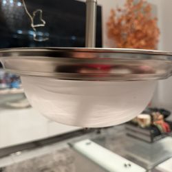 brushed/satin nickel semi-flush ceiling light with a frosted glass bowl,