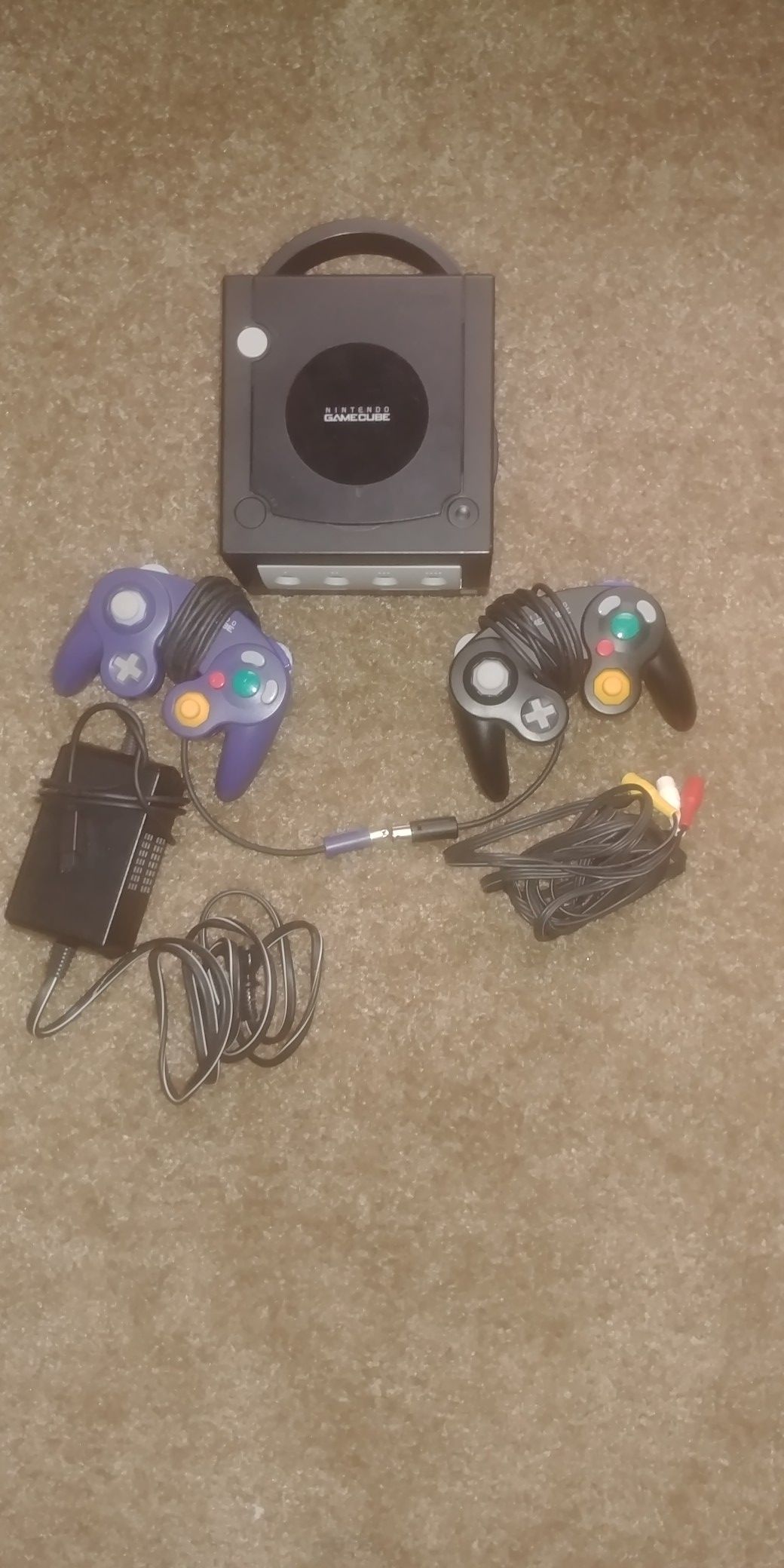 Nintendo GameCube with 2 controllers, Cables, Super Smash Bros., and Madden 06.