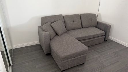 Gray Sectional Sofa with storage and pull out bed.