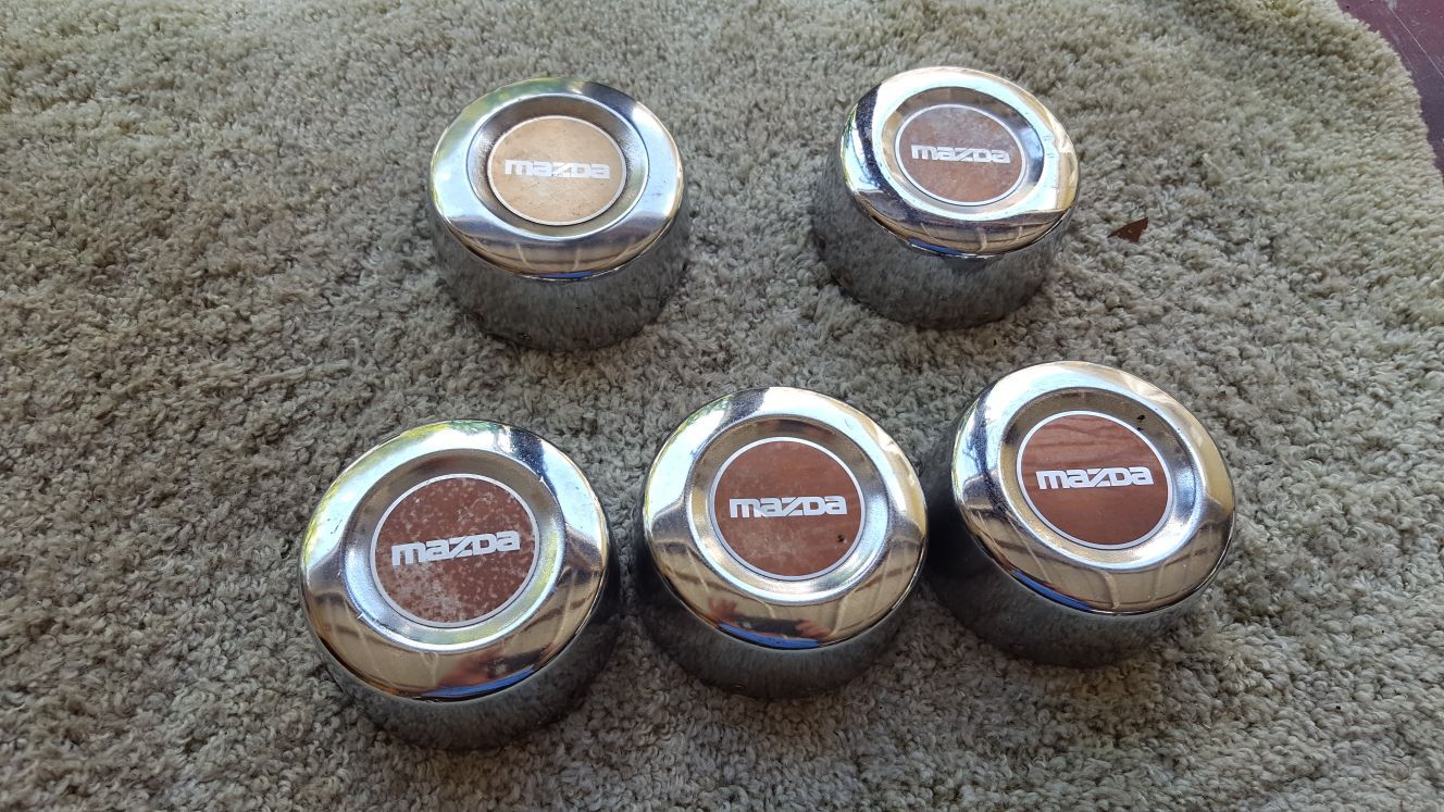 5 Mazda old school center caps$10.00 each