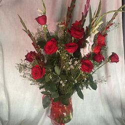 A dozen long stem red roses Full Arrangements in glass vase