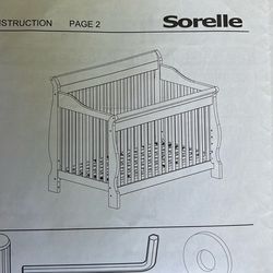 baby crib, sorelle brand, brown wood color!! bed cushion included as well.