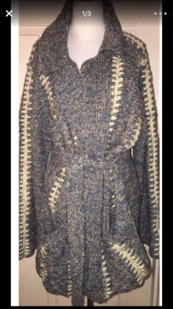 This is a true hippie jacket cardigan sweater made by kennington. There are no rips or TEARS. It also has two pockets on the on the front of the jack