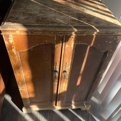 Antique or vintage wooden cabinet with brass