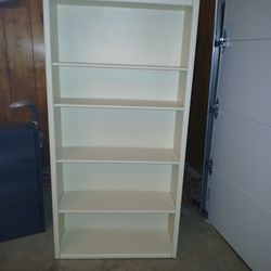 Solid wood 5 shelf bookcase. Will take 2 people to load.