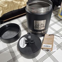 New, never used heavy duty metal coffee canister with press.