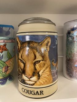 Call Of The Wild Mountain Lion Stein This magnificent stein features many faces of the beautiful Mountain Lion in full color. The mountain lions hypno