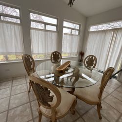 glass table with 5 cushion chairs