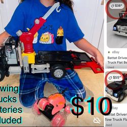 $10 huge Towing Truck Batteries included lights up and sounds a free car included