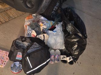 Bags of clothing, shoes stuffed animals and bags
